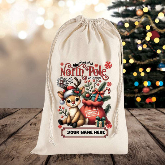 Personalized Christmas gift bag with reindeer design and 'North Pole Express' text on a wooden surface with a blurred Christmas tree in the background.